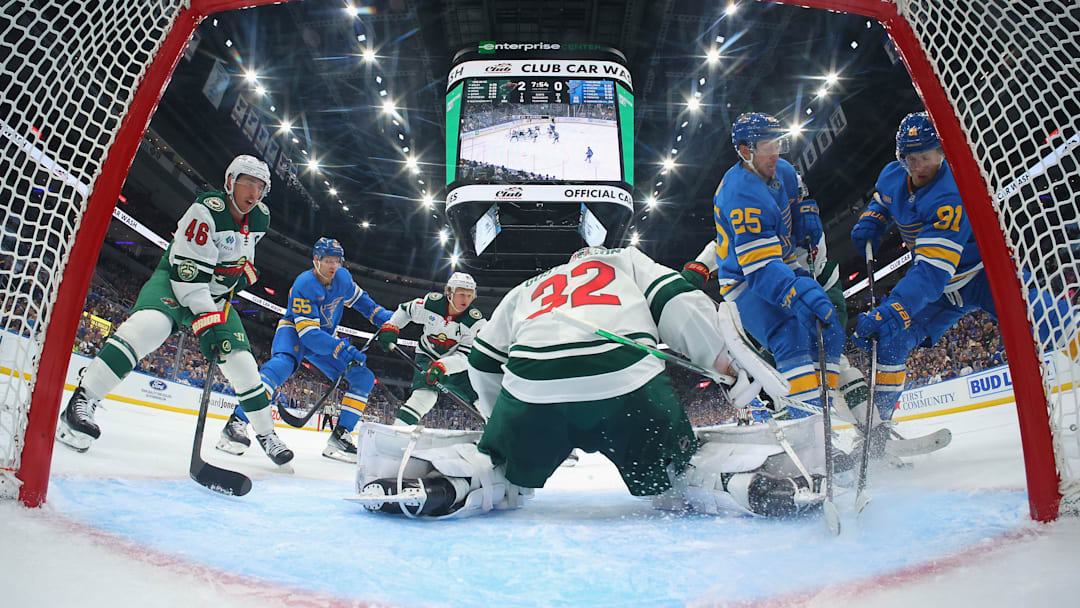 Forwards Dylan Holloway and Jordan Kyrou crashing towards the net in the season opener