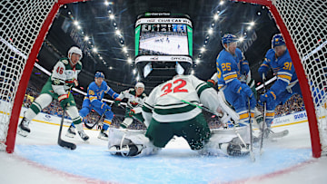 Forwards Dylan Holloway and Jordan Kyrou crashing towards the net in the season opener