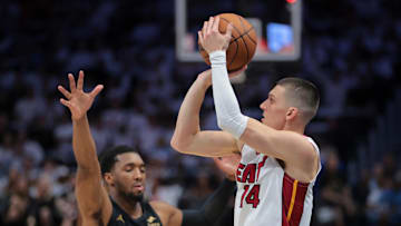 Apr 28, 2025; Miami, Florida, USA; Miami Heat guard Tyler Herro (14) shoots the basketball over Cleveland Cavaliers guard Donovan Mitchell (45) in the first quarter during game four for the first round of the 2025 NBA Playoffs at Kaseya Center. Mandatory Credit: Sam Navarro-Imagn Images