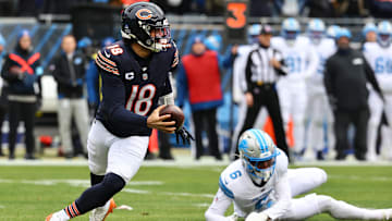 Caleb Williams eludes a tackle against Detroit and rolls right looking for a target.