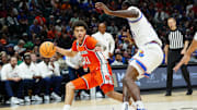 Nov 25, 2025; Las Vegas, Nevada, USA; Syracuse Orange guard Naithan George (11) dribbles the ball defended by Kansas Jayhawks forward Flory Bidunga (40) during the second half in a 2025 Players Era Festival group play game at MGM Grand Garden Arena. Mandatory Credit: Stephen R. Sylvanie-Imagn Images