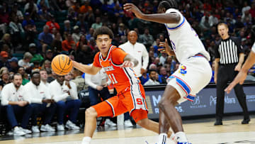 Nov 25, 2025; Las Vegas, Nevada, USA; Syracuse Orange guard Naithan George (11) dribbles the ball defended by Kansas Jayhawks forward Flory Bidunga (40) during the second half in a 2025 Players Era Festival group play game at MGM Grand Garden Arena. Mandatory Credit: Stephen R. Sylvanie-Imagn Images