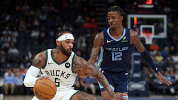 Oct 31, 2024; Memphis, Tennessee, USA; Milwaukee Bucks guard Gary Trent Jr. (5) dribbles as Memphis Grizzlies guard Ja Morant (12) defends during the first half at FedExForum. Mandatory Credit: Petre Thomas-Imagn Images