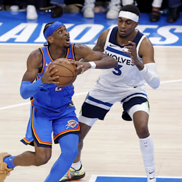 Oklahoma City Thunder guard Shai Gilgeous-Alexander (2) drives against Minnesota Timberwolves forward Jaden McDaniels (3) in the fourth quarter during game two of the western conference finals for the 2025 NBA Playoffs at Paycom Center on May 22.