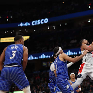 Nov 1, 2025; Washington, District of Columbia, USA; Washington Wizards guard CJ McCollum (3) shoots the ball as Orlando Magic guard Anthony Black (0) looks on in the second half at Capital One Arena. Mandatory Credit: Geoff Burke-Imagn Images