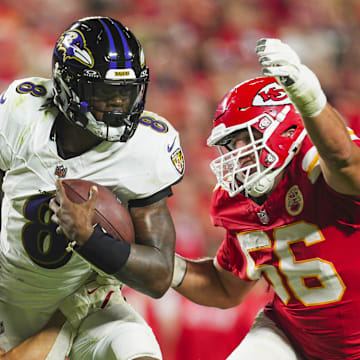 Baltimore Ravens quarterback Lamar Jackson is tackled by Kansas City Chiefs linebacker Leo Chenal. Mandatory Credit: Jay Biggerstaff-Imagn Images
