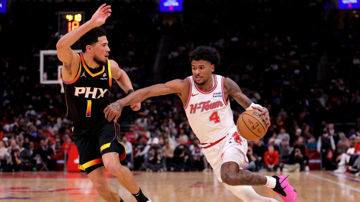 Dec 27, 2023; Houston, Texas, USA; Houston Rockets guard Jalen Green (4) handles the ball against Phoenix Suns guard Devin Booker (1) during the second quarter at Toyota Center. Mandatory Credit: Erik Williams-USA TODAY Sports