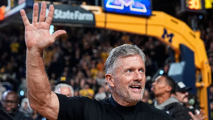 Michigan football head coach Kyle Whittingham waves at the crowd as he is being introduced on the floor during the first half between Michigan and USC at Crisler Center in Ann Arbor on Friday, Jan. 2, 2026.