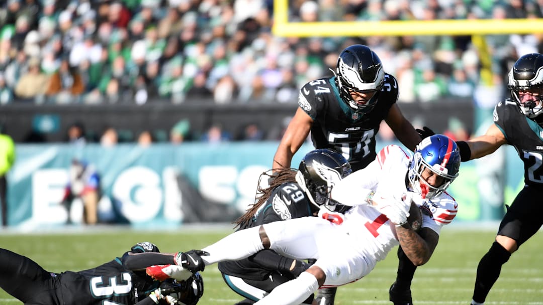 Jan 5, 2025; Philadelphia, Pennsylvania, USA; New York Giants wide receiver Malik Nabers (1) is tackled by Philadelphia Eagles cornerback Isaiah Rodgers (34) and  cornerback Avonte Maddox (29) during the second quarter at Lincoln Financial Field. Mandatory Credit: Eric Hartline-Imagn Images