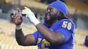 Oct 25, 2025; Pittsburgh, Pennsylvania, USA;  Pittsburgh Panthers offensive lineman Lyndon Cooper (56) leads the band in the victory song after defeating the North Carolina State Wolfpack at Acrisure Stadium. Mandatory Credit: Charles LeClaire-Imagn Images