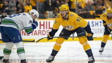 Apr 26, 2024; Nashville, Tennessee, USA:Nashville Predators right wing Michael McCarron (47) and Vancouver Canucks center Elias Lindholm (23) await the start of the match during the first period  in game three of the first round of the 2024 Stanley Cup Playoffs at Bridgestone Arena. Mandatory Credit: Steve Roberts-USA TODAY Sports