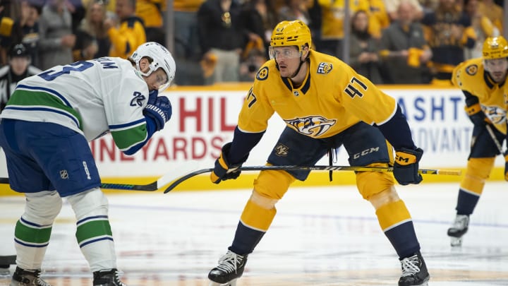 Apr 26, 2024; Nashville, Tennessee, USA:Nashville Predators right wing Michael McCarron (47) and Vancouver Canucks center Elias Lindholm (23) await the start of the match during the first period  in game three of the first round of the 2024 Stanley Cup Playoffs at Bridgestone Arena. Mandatory Credit: Steve Roberts-USA TODAY Sports