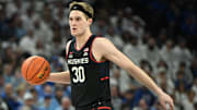 Feb 11, 2025; Omaha, Nebraska, USA;  Connecticut Huskies forward Liam McNeeley (30) dribbles against the Creighton Bluejays during the first half at CHI Health Center Omaha. Mandatory Credit: Steven Branscombe-Imagn Images