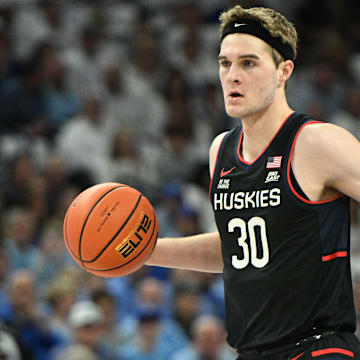 Feb 11, 2025; Omaha, Nebraska, USA;  Connecticut Huskies forward Liam McNeeley (30) dribbles against the Creighton Bluejays during the first half at CHI Health Center Omaha. Mandatory Credit: Steven Branscombe-Imagn Images