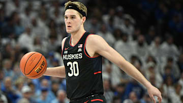 Feb 11, 2025; Omaha, Nebraska, USA;  Connecticut Huskies forward Liam McNeeley (30) dribbles against the Creighton Bluejays during the first half at CHI Health Center Omaha. Mandatory Credit: Steven Branscombe-Imagn Images