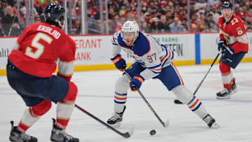 Edmonton Oilers center Connor McDavid (97) moves the puck as Florida Panthers defenseman Aaron Ekblad (5)
