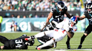 Jan 5, 2025; Philadelphia, Pennsylvania, USA; New York Giants wide receiver Malik Nabers (1) is tackled by Philadelphia Eagles cornerback Isaiah Rodgers (34) and cornerback Avonte Maddox (29) during the second quarter at Lincoln Financial Field.  