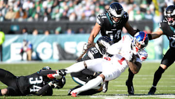 Jan 5, 2025; Philadelphia, Pennsylvania, USA; New York Giants wide receiver Malik Nabers (1) is tackled by Philadelphia Eagles cornerback Isaiah Rodgers (34) and cornerback Avonte Maddox (29) during the second quarter at Lincoln Financial Field.  