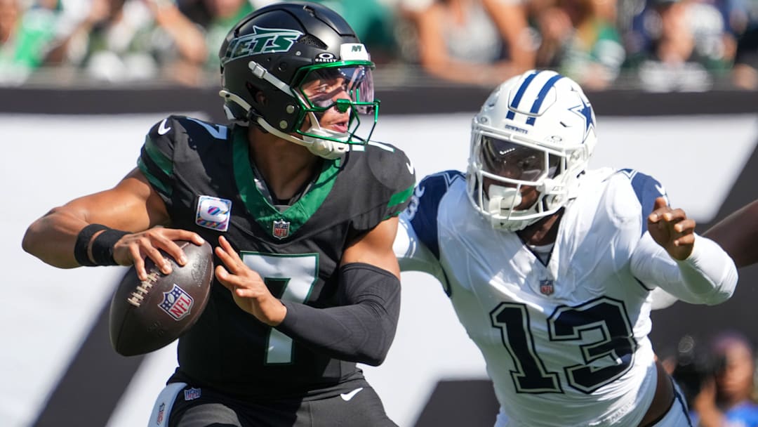 Oct 5, 2025; East Rutherford, New Jersey, USA; New York Jets quarterback Justin Fields (7) is pressured by Dallas Cowboys defensive end Dante Fowler Jr. (13) during the first half at MetLife Stadium.