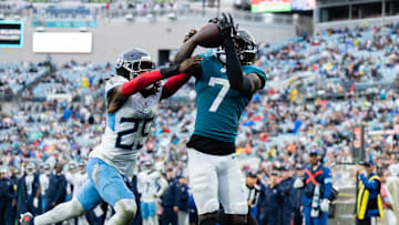 Dec 29, 2024; Jacksonville, Florida, USA; Jacksonville Jaguars wide receiver Brian Thomas Jr (7) catches the ball for a touchdown against Tennessee Titans cornerback Jarvis Brownlee Jr. (29) in the fourth quarter at EverBank Stadium. Mandatory Credit: Jeremy Reper-Imagn Images