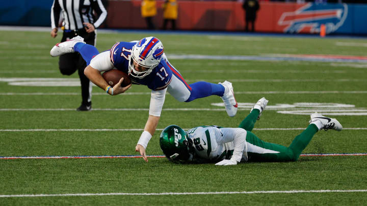 Buffalo Bills quarterback Josh Allen (17) is tackled by New York Jets running back Israel Abanikanda (25) after a short gain.