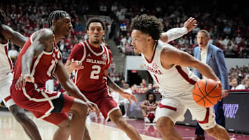 Jan 4, 2025; Tuscaloosa, AL, USA; Oklahoma forward Jalon Moore (14) guards Alabama guard Mark Sears (1) as he dribble-drives on the baseline at Coleman Coliseum. Alabama defeated Oklahoma 107-79. Mandatory Credit: Gary Cosby Jr.-Tuscaloosa News
