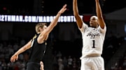 Feb 26, 2025; College Station, Texas, USA; Texas A&M Aggies guard Zhuric Phelps (1) shoots a three point basket over Vanderbilt Commodores guard Tyler Nickel (5) during the first half at Reed Arena.  