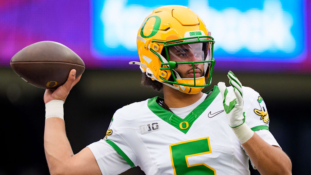 Oregon quarterback Dante Moore warms up as the Oregon Ducks take on the Washington Huskies on Nov. 29, 2025, at Husky Stadium in Seattle, Washington. Oregon quarterback Dante Moore warms up as the Oregon Ducks take on the Washington Huskies on Nov. 29, 2025, at Husky Stadium in Seattle, Washington.
