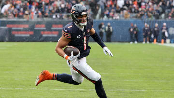 Dec 31, 2023; Chicago, Illinois, USA; Chicago Bears quarterback Justin Fields (1) rushes for a touchdown against the Atlanta Falcons during the first half at Soldier Field. Mandatory Credit: Mike Dinovo-USA TODAY Sports