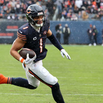 Dec 31, 2023; Chicago, Illinois, USA; Chicago Bears quarterback Justin Fields (1) rushes for a touchdown against the Atlanta Falcons during the first half at Soldier Field. Mandatory Credit: Mike Dinovo-USA TODAY Sports