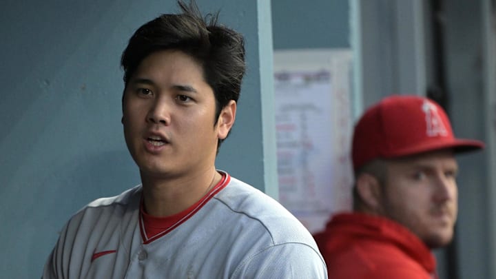 Angels designated hitter Shohei Ohtani (17) and center fielder Mike Trout (27) look on from the dugout during the game against the Los Angeles Dodgers at Dodger Stadium on July 8, 2023.