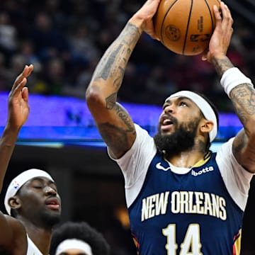 Dec 21, 2023; Cleveland, Ohio, USA; New Orleans Pelicans forward Brandon Ingram (14) drives against Cleveland Cavaliers guard Caris LeVert (3) in the second quarter at Rocket Mortgage FieldHouse. Mandatory Credit: David Richard-Imagn Images