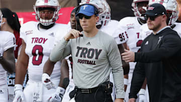 Sep 17, 2022; Boone, North Carolina, USA; Troy Trojans defensive coordinator Shiel Wood (middle) watches the action against the Appalachian State Mountaineers during the second half at Kidd Brewer Stadium. Mandatory Credit: Reinhold Matay-Imagn Images