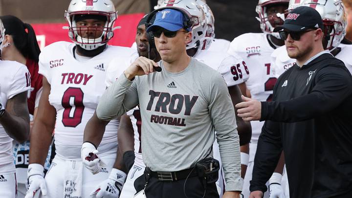 Sep 17, 2022; Boone, North Carolina, USA; Troy Trojans defensive coordinator Shiel Wood (middle) watches the action against the Appalachian State Mountaineers during the second half at Kidd Brewer Stadium. Mandatory Credit: Reinhold Matay-Imagn Images
