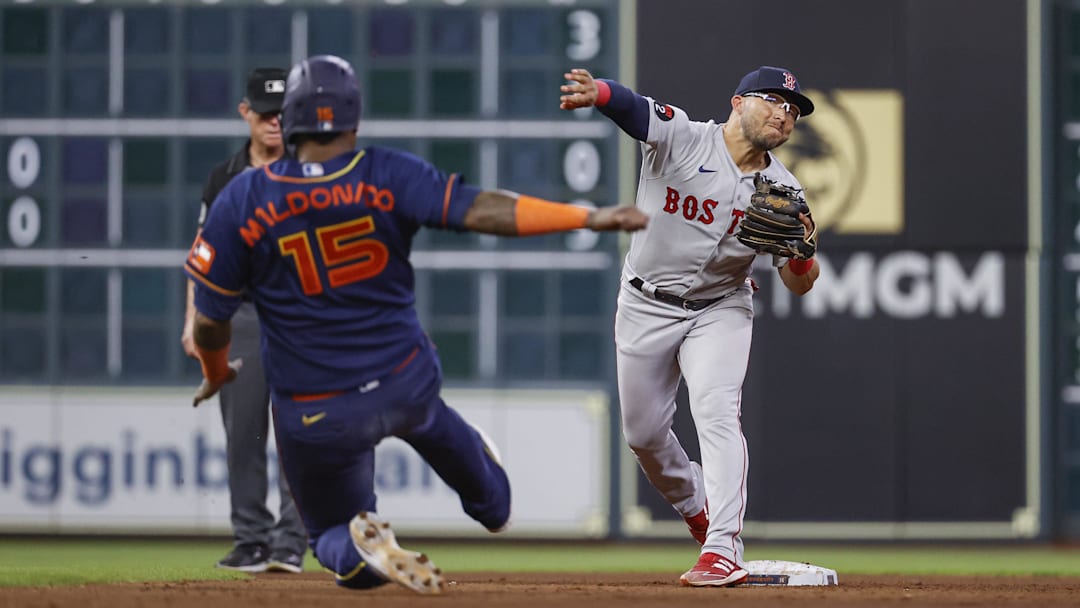 Houston Astros catcher Martin Maldonado (15) is out at second base as Boston Red Sox second baseman Yolmer Sanchez (47) throws to first base to complete a double play during the seventh inning at Minute Maid Park on Aug. 1, 2022.
