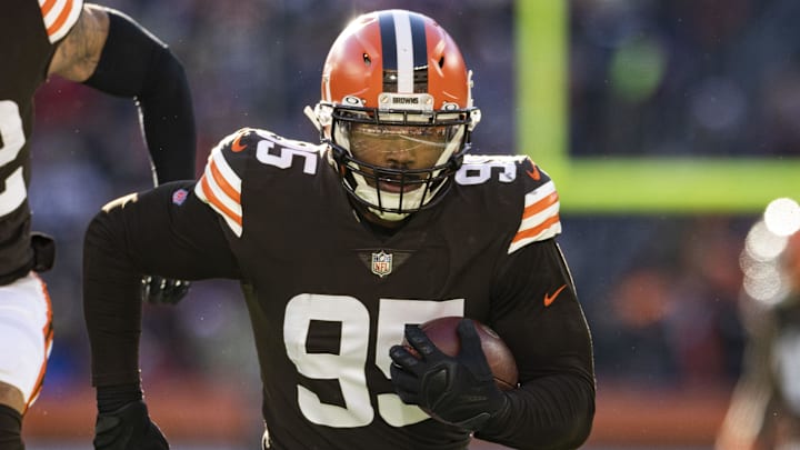 Dec 12, 2021; Cleveland, Ohio, USA; Cleveland Browns defensive end Myles Garrett (95) returns a fumble for a touchdown against the Baltimore Ravens during the second quarter at FirstEnergy Stadium. Mandatory Credit: Scott Galvin-Imagn Images