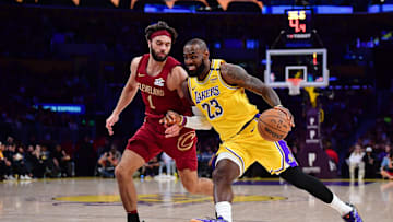 Dec 31, 2024; Los Angeles, California, USA; Los Angeles Lakers forward LeBron James (23) moves to the basket against Cleveland Cavaliers guard Max Strus (1) during the first half at Crypto.com Arena. Mandatory Credit: Gary A. Vasquez-Imagn Images