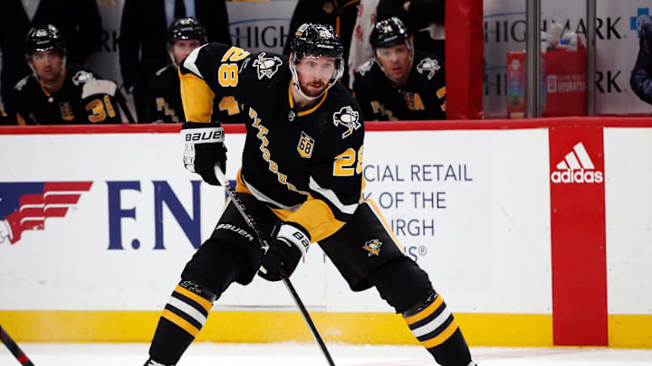 Feb 18, 2024; Pittsburgh, Pennsylvania, USA;  Pittsburgh Penguins defenseman Marcus Pettersson (28) skates with the puck against the Los Angeles Kings during the third period at PPG Paints Arena. Mandatory Credit: Charles LeClaire-Imagn Images