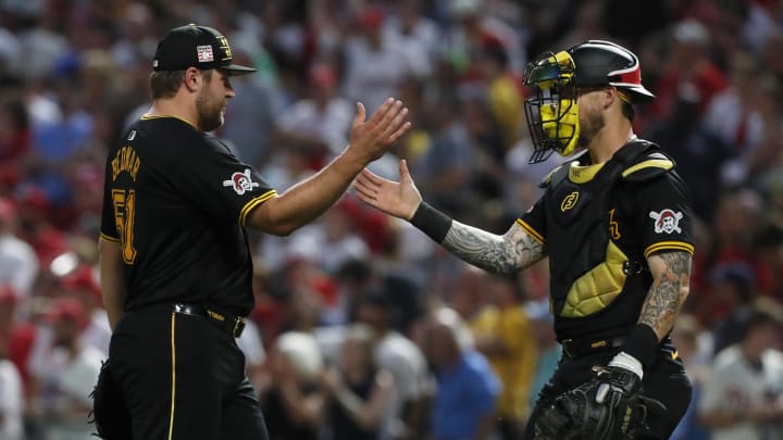 Jul 20, 2024; Pittsburgh, Pennsylvania, USA;  Pittsburgh Pirates relief pitcher David Bednar (51) and catcher Yasmani Grandal (6) shake hands after defeating the Philadelphia Phillies at PNC Park. The Pirates won 4-1. Mandatory Credit: Charles LeClaire-USA TODAY Sports