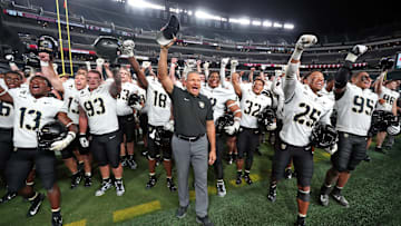 Army Black Knights head coach Jeff Monken celebrates with his team after beating the Temple Owls.