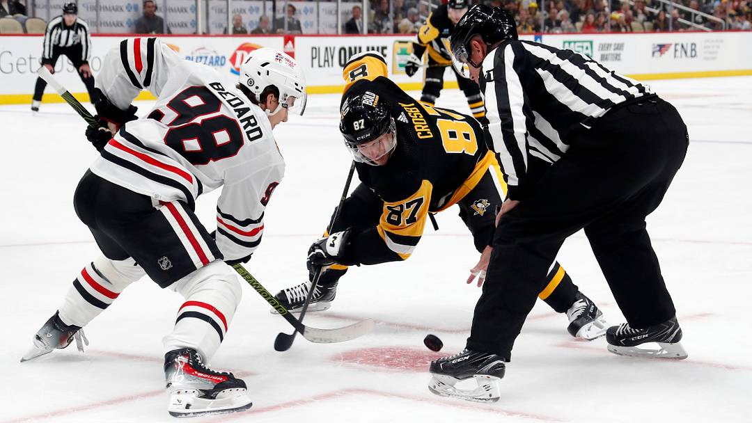 Chicago Blackhawks' Connor Bedard (98) and Pittsburgh Penguins' Sidney Crosby (87) take a face-off during the third period at the PPG Paints Arena. Chicago won 4-2.  Mandatory Credit: Charles LeClaire-USA TODAY Sports