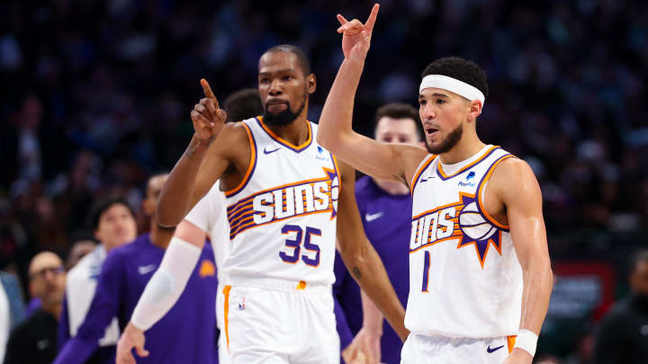 Jan 24, 2024; Dallas, Texas, USA;  Phoenix Suns guard Devin Booker (1) celebrates with Phoenix Suns forward Kevin Durant (35) during the third quarter against the Dallas Mavericks at American Airlines Center. Mandatory Credit: Kevin Jairaj-USA TODAY Sports