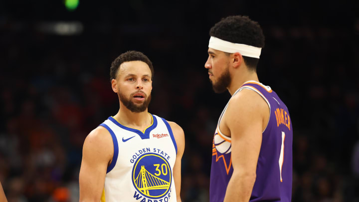 Dec 12, 2023; Phoenix, Arizona, USA; Golden State Warriors guard Chris Paul (3) and  Stephen Curry (30) alongside Phoenix Suns guard Devin Booker (1) at Footprint Center. Mandatory Credit: Mark J. Rebilas-USA TODAY Sports