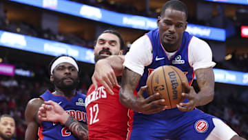 Oct 24, 2025; Houston, Texas, USA; Detroit Pistons guard Javonte Green (31) grabs a rebound from Houston Rockets center Steven Adams (12) during the second quarter at Toyota Center.