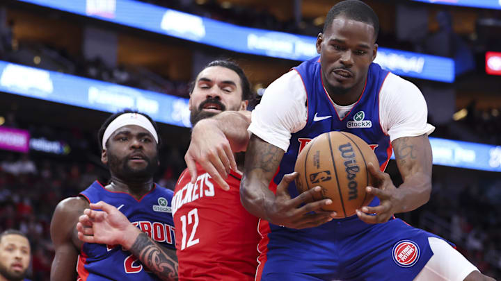 Oct 24, 2025; Houston, Texas, USA; Detroit Pistons guard Javonte Green (31) grabs a rebound from Houston Rockets center Steven Adams (12) during the second quarter at Toyota Center.