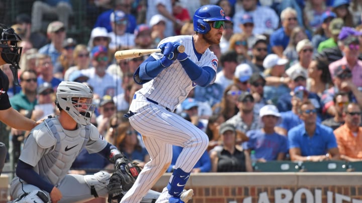 Aug 22, 2024; Chicago, Illinois, USA;  Chicago Cubs right fielder Cody Bellinger (24) hits an RBI single during the fourth inning against the Detroit Tigers at Wrigley Field. Mandatory Credit: Patrick Gorski-USA TODAY Sports