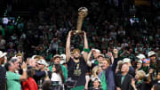 Jun 17, 2024; Boston, Massachusetts, USA; Boston Celtics forward Jayson Tatum (0) lifts the trophy after winning the 2024 NBA Finals against the Dallas Mavericks at TD Garden. Mandatory Credit: Peter Casey-USA TODAY Sports