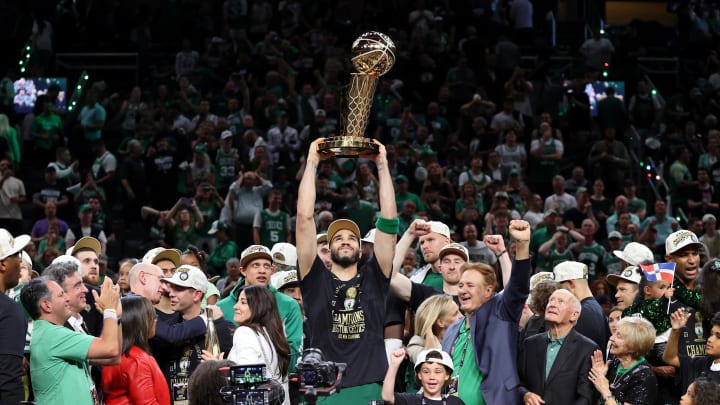 Jun 17, 2024; Boston, Massachusetts, USA; Boston Celtics forward Jayson Tatum (0) lifts the trophy after winning the 2024 NBA Finals against the Dallas Mavericks at TD Garden. Mandatory Credit: Peter Casey-USA TODAY Sports