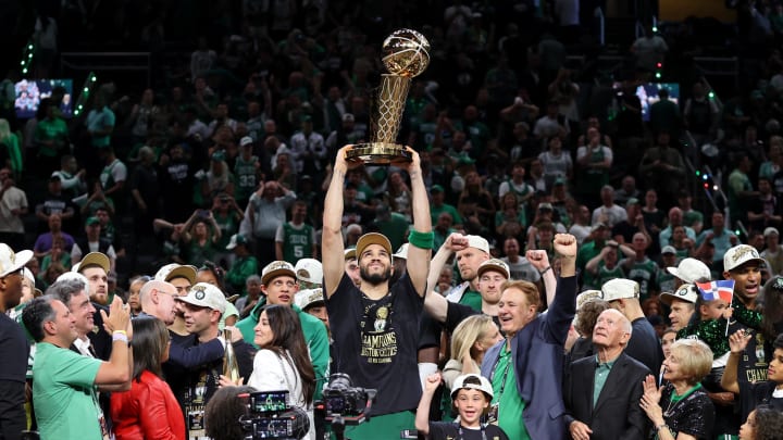 Jun 17, 2024; Boston, Massachusetts, USA; Boston Celtics forward Jayson Tatum (0) lifts the trophy after winning the 2024 NBA Finals against the Dallas Mavericks at TD Garden. 