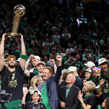 Jun 17, 2024; Boston, Massachusetts, USA; Boston Celtics forward Jayson Tatum (0) lifts the trophy after winning the 2024 NBA Finals against the Dallas Mavericks at TD Garden. Mandatory Credit: Peter Casey-USA TODAY Sports